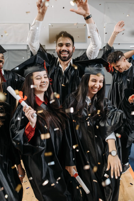 Graduating students celebrating academic success with confetti